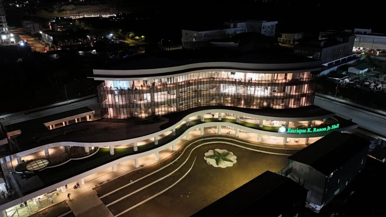 Aerial night view of the campus building and plaza landscaping at De La Salle University Laguna Campus