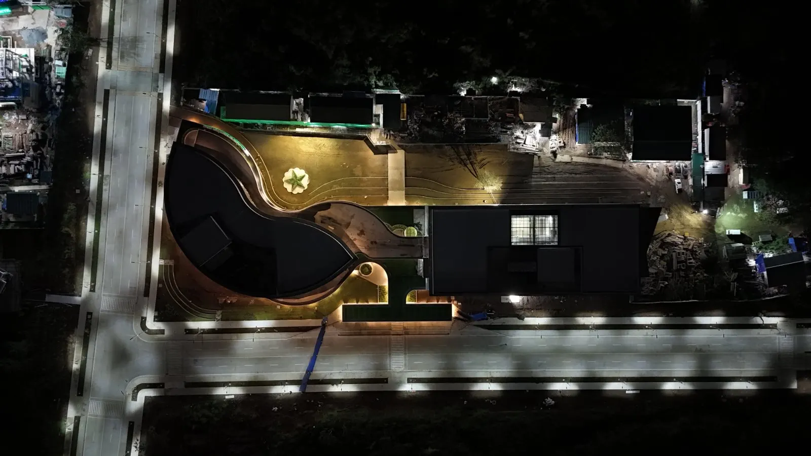 Aerial night view of a landscaped plaza feature at De La Salle University Laguna Campus
