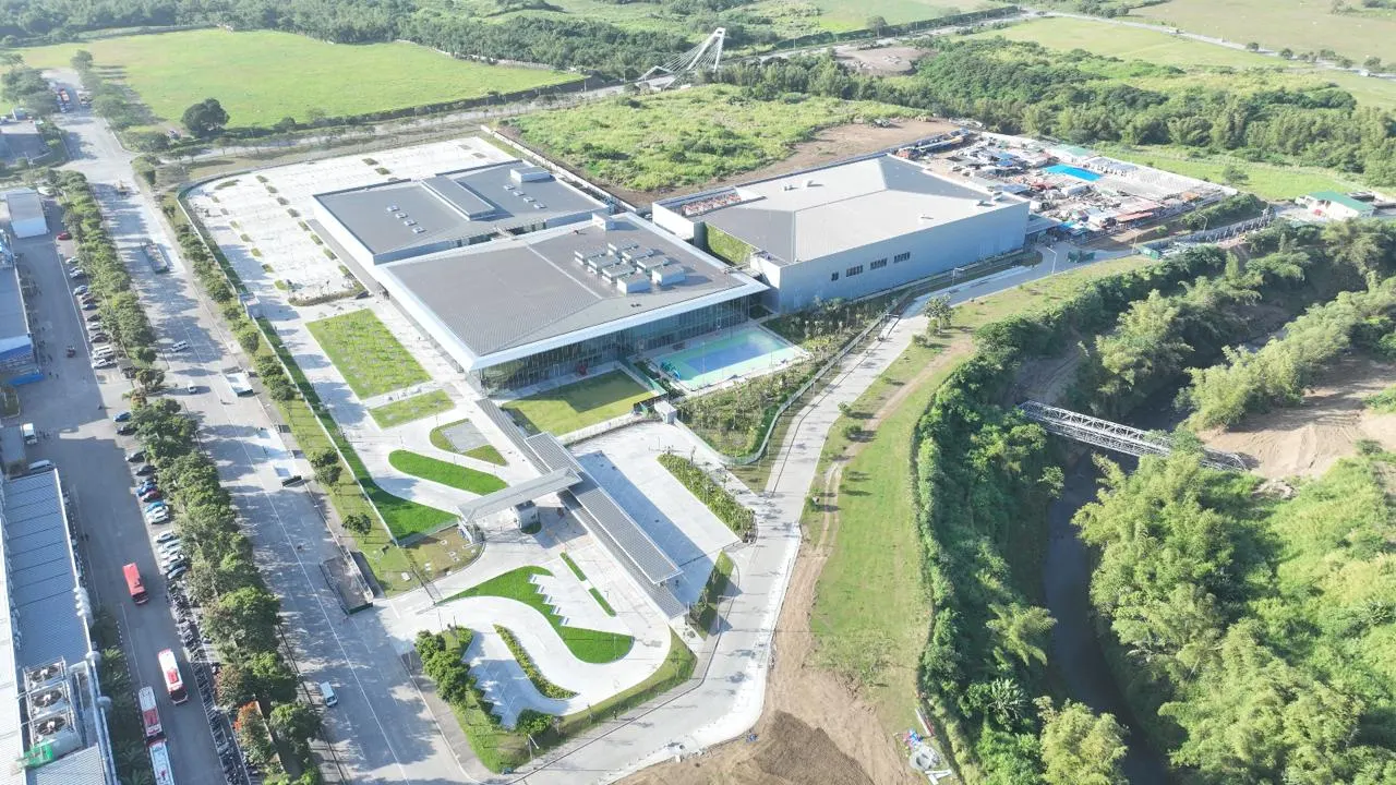 Aerial view of the campus lawn and water feature at the finished manufacturing campus