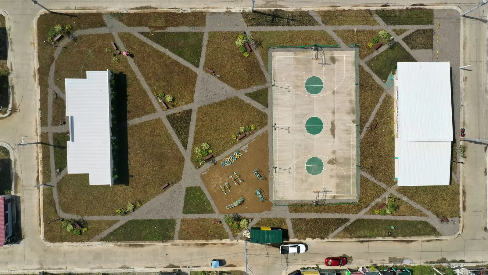 After: fully landscaped basketball court with diamond garden beds and full lawn