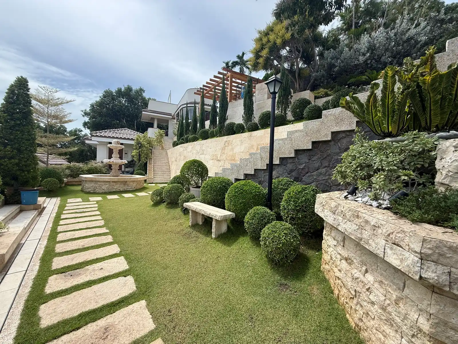 Terraced lawn with shaped topiary at a Punta Fuego private estate