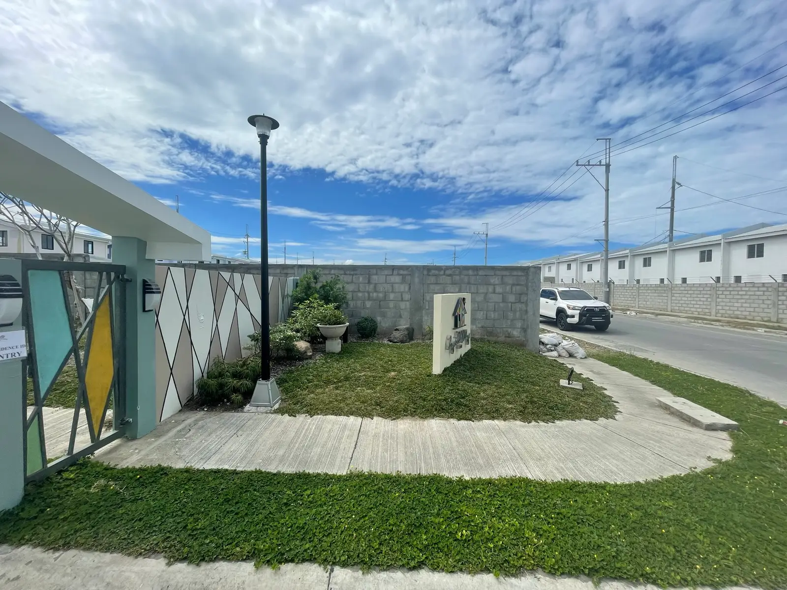 Paved entrance court and monument signage, a Raemulan Lands community